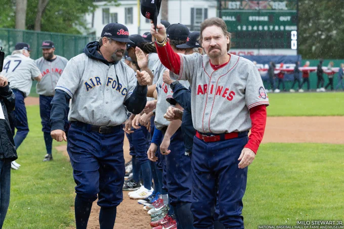 Wade Boggs, right, tips his cap to fans as Todd Helton joins him on the third base line during pregame introductions at the Hall of Fame Military Classic. (Milo Stewart Jr./National Baseball Hall of Fame and Museum)