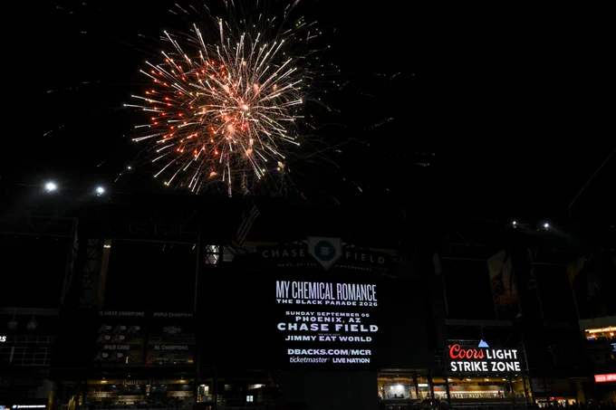 Fireworks erupt in the sky over Chase Field. The scoreboard shows a promo for My Chemical Romance's The Black Parade Tour at Chase Field.