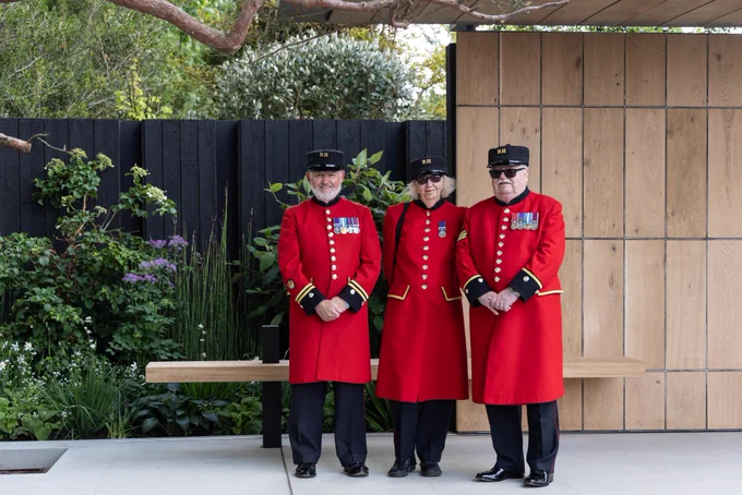 Three Chelsea Pensioners post on the Asthma and Lung UK Breathing Space garden.