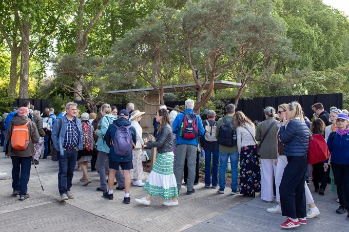 A crowd gathers at the Asthma and Lung UK breathing space garden.