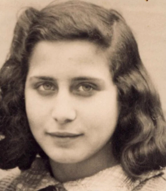 Black and white portrait of a young girl with wavy hair, looking directly at the camera.

