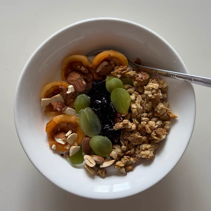 fruits yogurt bowl (green grapes and loquats) with oats granola crushed toasted almonds and blackberries compote that my mom made