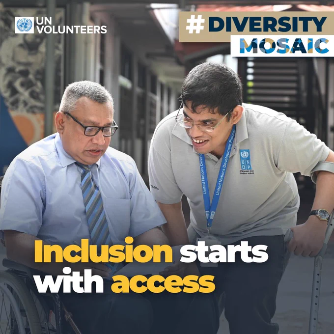 Two men, one in a wheelchair and the other with crutches, engage in conversation outside a building promoting inclusion and access.