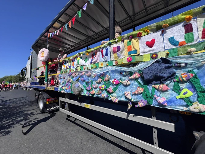 Carnival float with knitted tableau on side