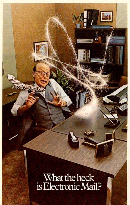 A businessman jumps in fright as a sparkling electronic line zips around his office to drop off a single physical letter on his desk. Text reads "What the heck is Electronic Mail?" 