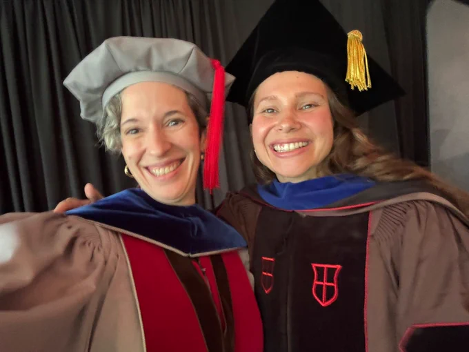 Selfie of Theresa Desrochers and Hannah Hyde (née Doyle) in regalia at graduation 