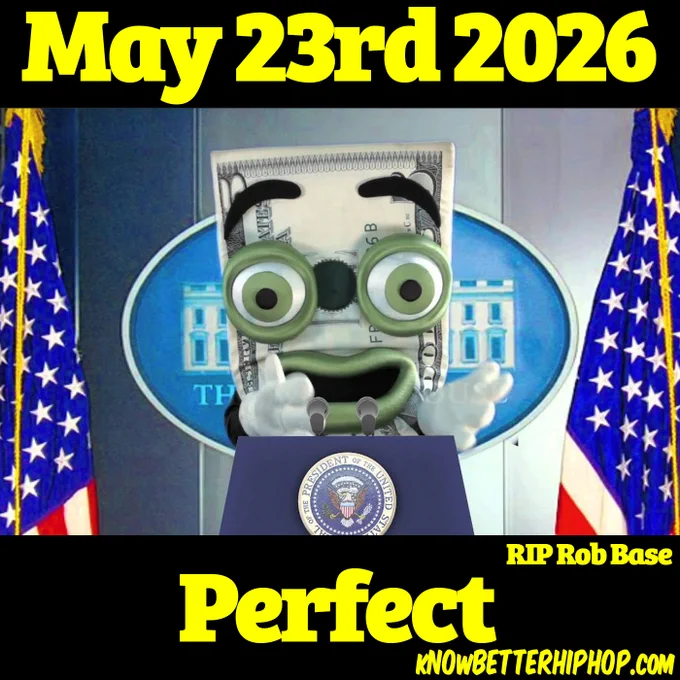 A digital collage features a puppet character made to look like a folded United States dollar bill with large, round green eyes and thick black eyebrows, standing behind a presidential podium bearing the Seal of the President of the United States. The character is positioned as if giving a speech at the White House press briefing room, flanked by two American flags with the White House emblem visible in the background. The entire image is enclosed by thick black borders at the top and bottom containing bold yellow text: "May 23rd 2026" at the top, "Perfect" at the bottom, and a smaller note reading "RIP Rob Base" on the right. The website "KNOWBETTERHIPHOP.COM" is printed in small yellow text in the bottom right corner.