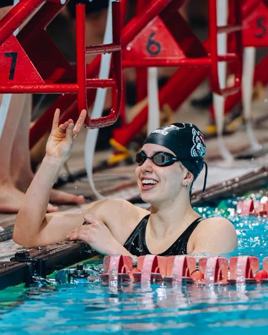 Image of Leah Shackley celebrating with tuffy hands after race.