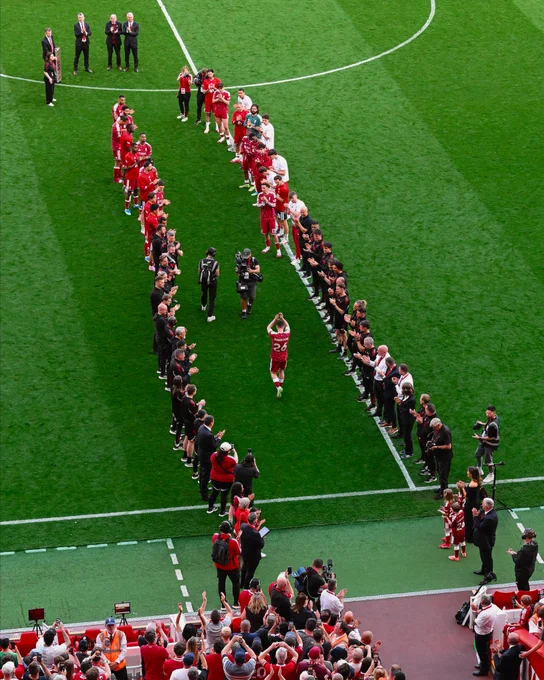 Photography of Andy Robertson as he walks out to a guard of honor at Anfield.