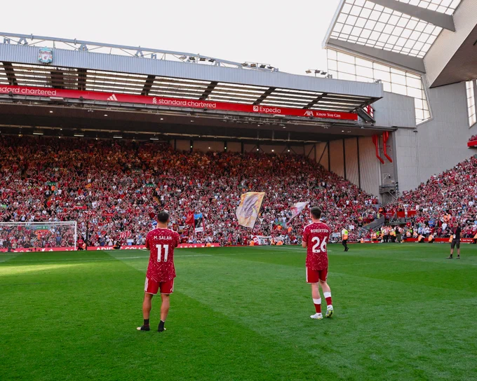 Photography of Mo Salah and Andy Robertson as Anfield sings You'll Never Walk Alone.