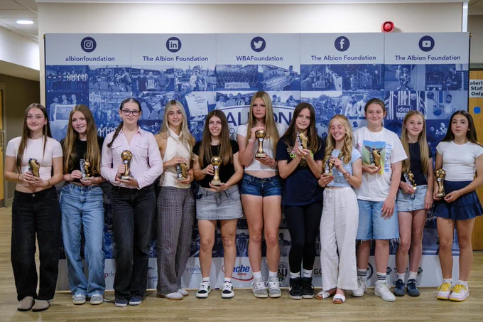 Individual awards winners from all teams standing in front of an Albion Foundation backdrop.