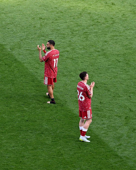 Photography of Mo Salah and Andy Robertson applauding the fans at full-time.