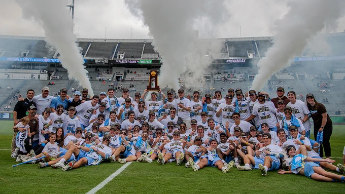 The Tufts Men's lacrosse team poses for a photo with the NCAA National Championship following their victory on May 24, 2026. Photo: Stephen Blue/Sideline Media