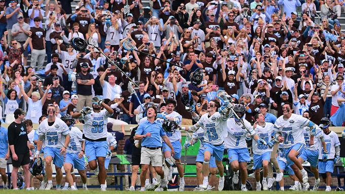 Members of the Tufts men's lacrosse team run onto the field to celebrate following the NCAA National Championship on May 24, 2026. Photo: Stephen Blue/Sideline Media