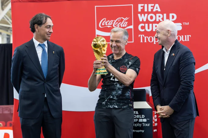 Prime Minister Mark Carney holds the FIFA World Cup trophy during a ‘Canada Celebrates’ FIFA World Cup 26™ event in Ottawa. 