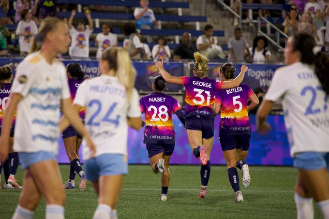 Carolina Ascent FC players Lily Nabet, Mackenzie George, and Jenna Butler celebrate Jill Aguilera’s Olimpico goal on Saturday, May 16. (Sam Spencer for Soccer Sheet)