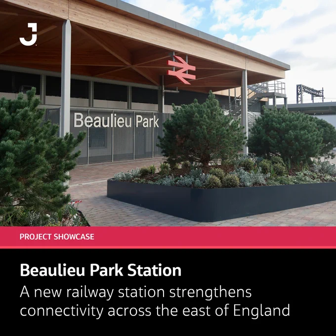 Modern Beaulieu Park railway station entrance with landscaped greenery and clear signage under a wooden canopy.