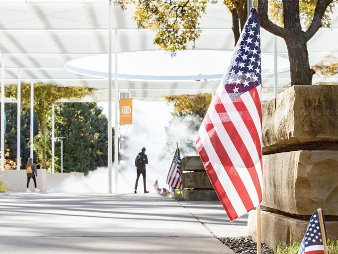 a file photo of an American flag displayed along the Margaret McDermott Mall on the UT Dallas campus