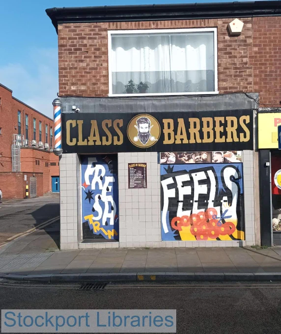 Class Barbers shop front with graffiti art and a traditional barber's pole.