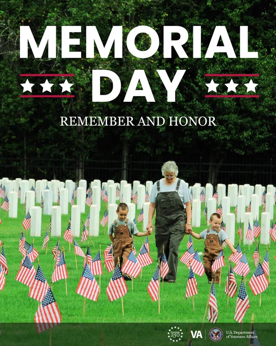 Adult and two children walking hand-in-hand through a cemetery filled with American flags on Memorial Day.