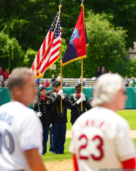 A color guard holds the American flag during a pregame ceremony at Doubleday Field. (Daniel Shirey/MLB Photos)