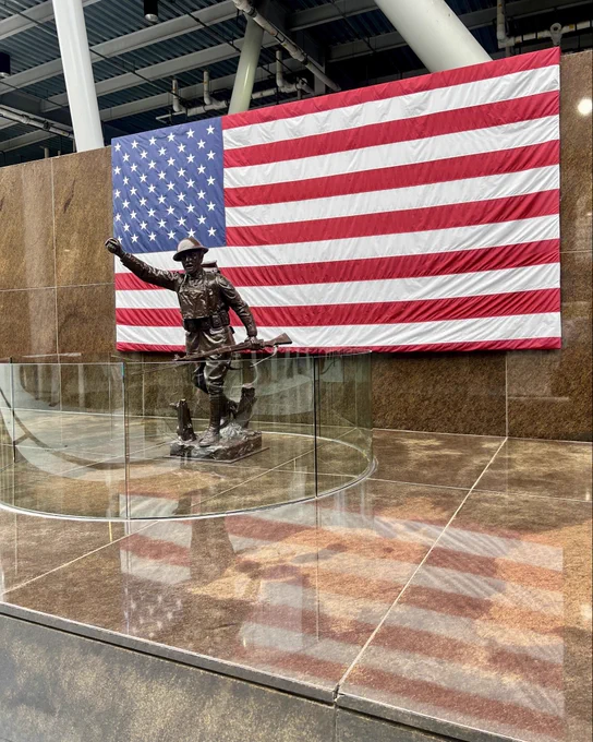 Photo of bronze military statue and American flag