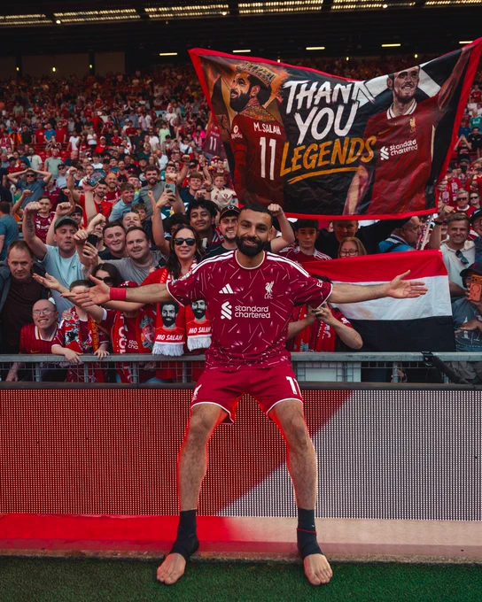 Mo Salah posing in front of the Kop.
