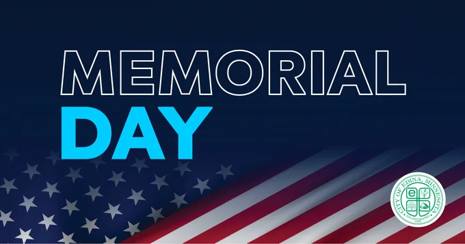 Memorial Day graphic with the words “Memorial Day” in large white and blue text over a dark blue background. An American flag spans the bottom half of the image, and the City of Edina logo appears in the lower right corner.