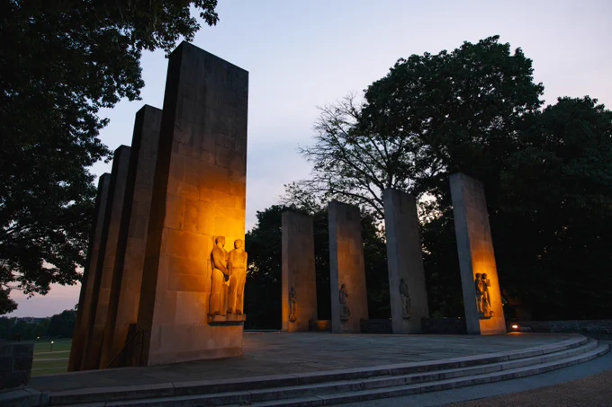The Pylons are seen illuminated at dusk.