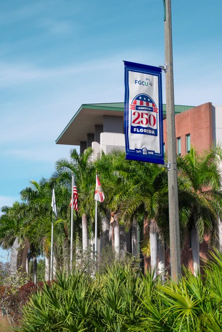 a photo of a flag banner that reads 250 florida in front of lutgert hall