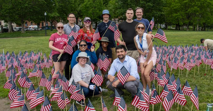 University of Massachusetts employees standing together on Boston Common to plant American Flags in honor of Memorial Day.