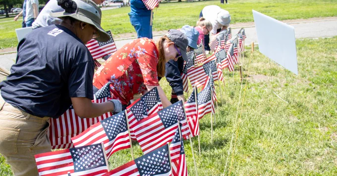 University of Massachusetts employees planting American Flags in honor of Memorial Day on the Boston Common.