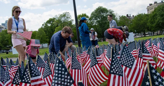 University of Massachusetts employees planting American Flags in honor of Memorial Day on the Boston Common.