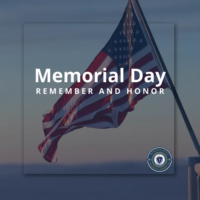 American flag waving against a clear sky with Memorial Day remembrance text overlay.