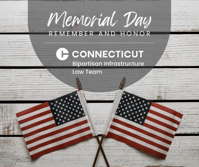 Two American flags on a white wooden background with Memorial Day remembrance text and the Connecticut Bipartisan Infrastructure Law Team logo