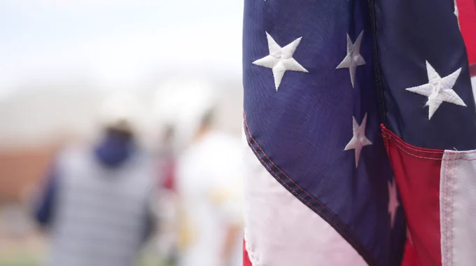 A blurred photo with the American flag in focus.