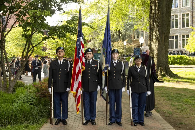 ROTC members hold Flags on a sunny copley lawn