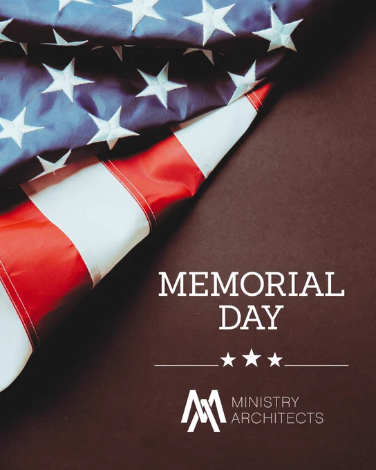 A close-up of a folded American flag on a brown background with 'Memorial Day' and 'Ministry Architects' text. The image conveys a respectful and solemn mood.