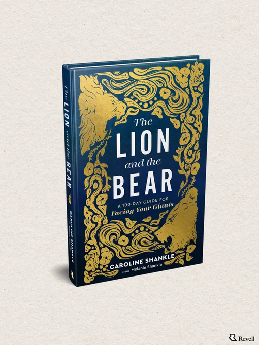 This is an image of a book titled "The Lion and the Bear" by Caroline Shankle, with Melanie Shankle. The cover is dark with gold decorative designs featuring a lion and a bear. The publisher's logo, Revell, is at the bottom right.