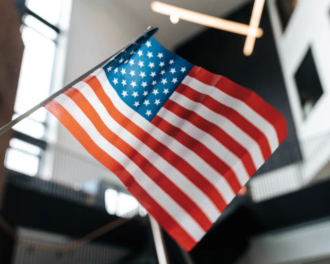 A photo of a flag in the Academic Center with the background blurred.