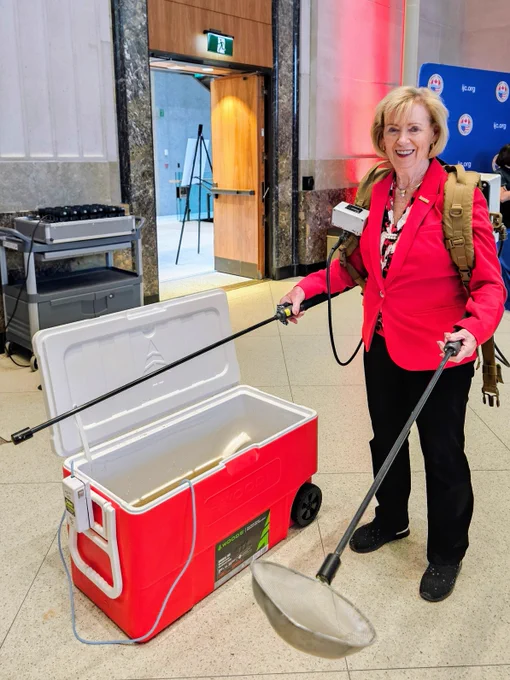 Canadian MP Hon. Judy Sgro tries out an electro fishing unit on Parliament Hill. By feeling the weight of the unit, testing the coordination required to make it work, and experiencing first-hand how much goes in to lamprey larval assessment, elected officials come to better understand the challenges and importance of the work being done in the Great Lakes by the Great Lakes Fishery Commission and our partners.