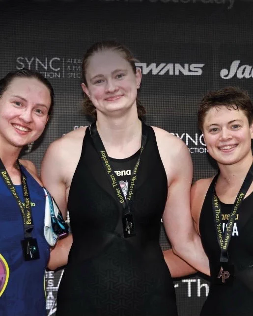 Image of Eneli Jefimova on the podium after winning gold in the 50m breaststroke at the AP Race London International. 