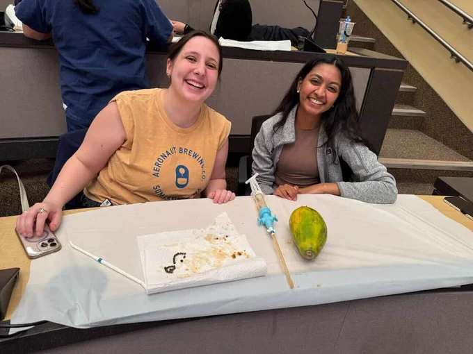Medical students with an MVA kit and papaya.