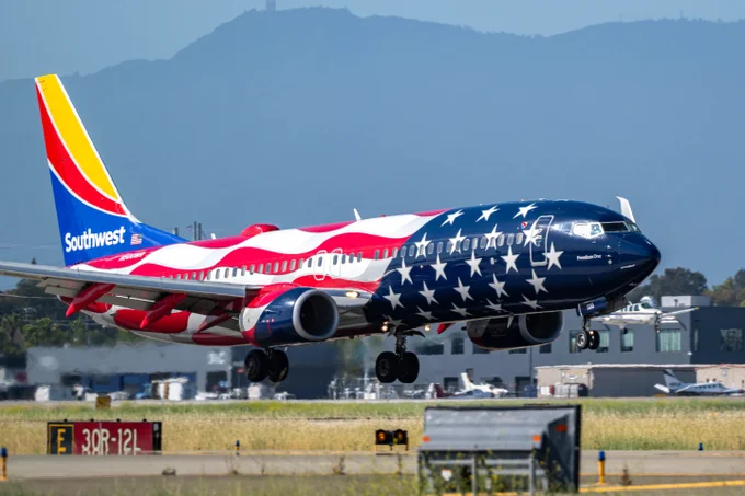 A red, white and blue plane soars over SJC.