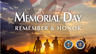 A background photo of three silhouetted soldiers standing before a vibrant sunset is overlaid with a slightly transparent photo of saluting soldier standing before a waving American flag. Above that white text reads: “Memorial Day. Remember & Honor”, with the official seals for the National Security Agency and the Central Security Service below the text.