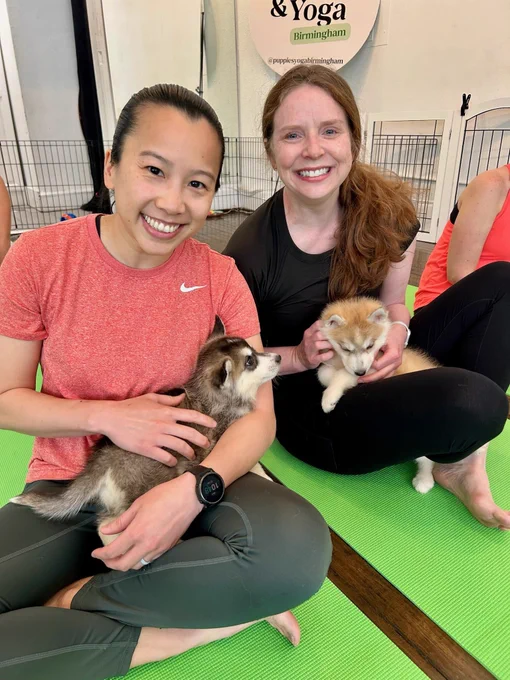 Members of the UAB Division of Breast & Endocrine Surgery with puppies in yoga class