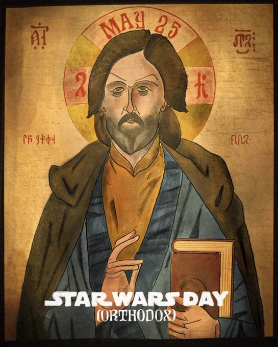 A grey-bearded Luke Skywalker is depicted in the style of an Orthodox Christian icon. He wears a golden undertunic, blue outer tunic, and a brown robe. In his left hand he holds the Rammahgon, a red volume of the sacred Jedi texts. He is haloed in gold with red text. Above his head is the phrase "May 25", on either side of his head are symbols written in Kitissakkullian, a language of the ancient Jadi texts. At the bottom of the image, painted over the icon, in white is the phrase "Star Wars Day (Orthodox)."