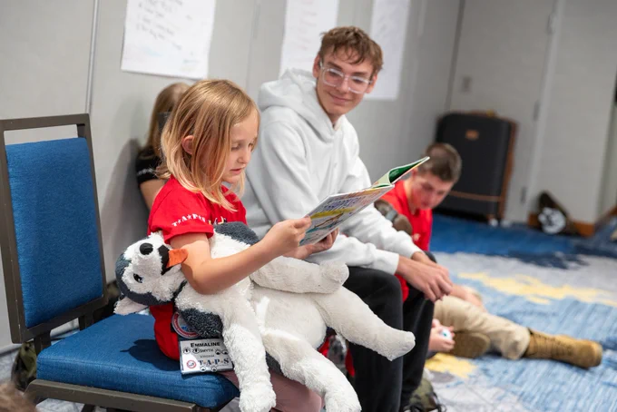 Military children read story books at the 32nd annual TAPS grand banquet in Arlington, Va., on May 23, 2026. (Courtesy of TAPS)