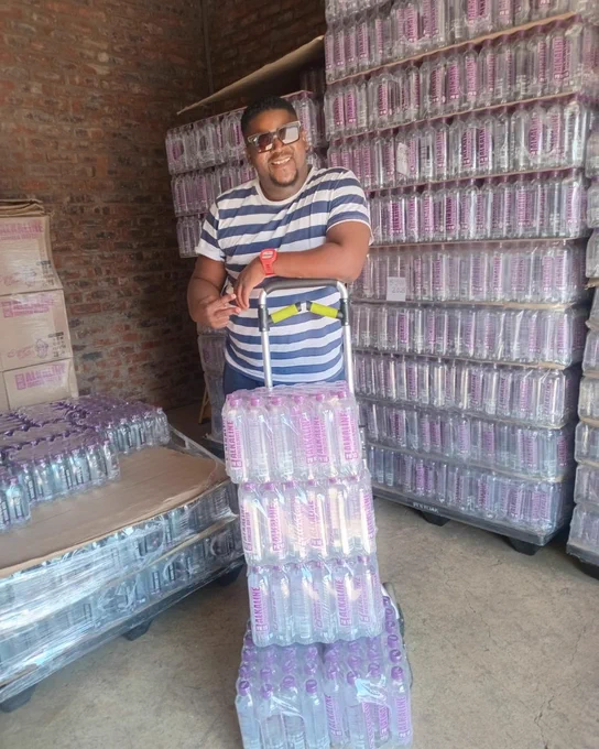 A picture of Prince with his Designer Water pH10 cases in a warehouse in Alberton, South Africa.