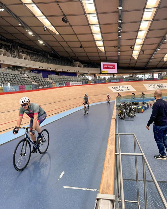 Cyclists riding along the indoor track at Lee Valley VeloPark during a track session.